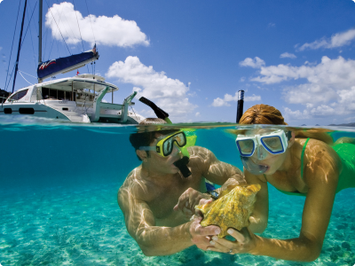 Couple on yacht charter vacation snorkeling in the Virgin Islands