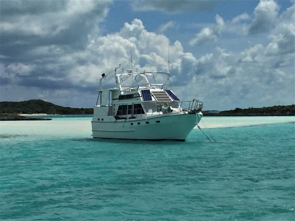 An appealing motor yacht anchored on a sandbar. An example of a bareboat charter in the Caribbean. 
